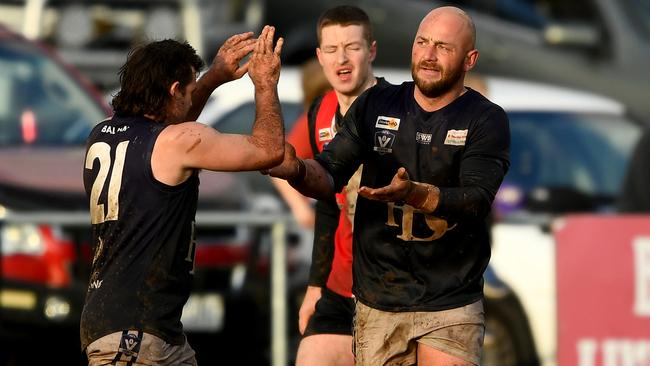 Harley Bongart of Ballan is congratulated by a teammate after kicking a goal against Creswick. Photo by Josh Chadwick