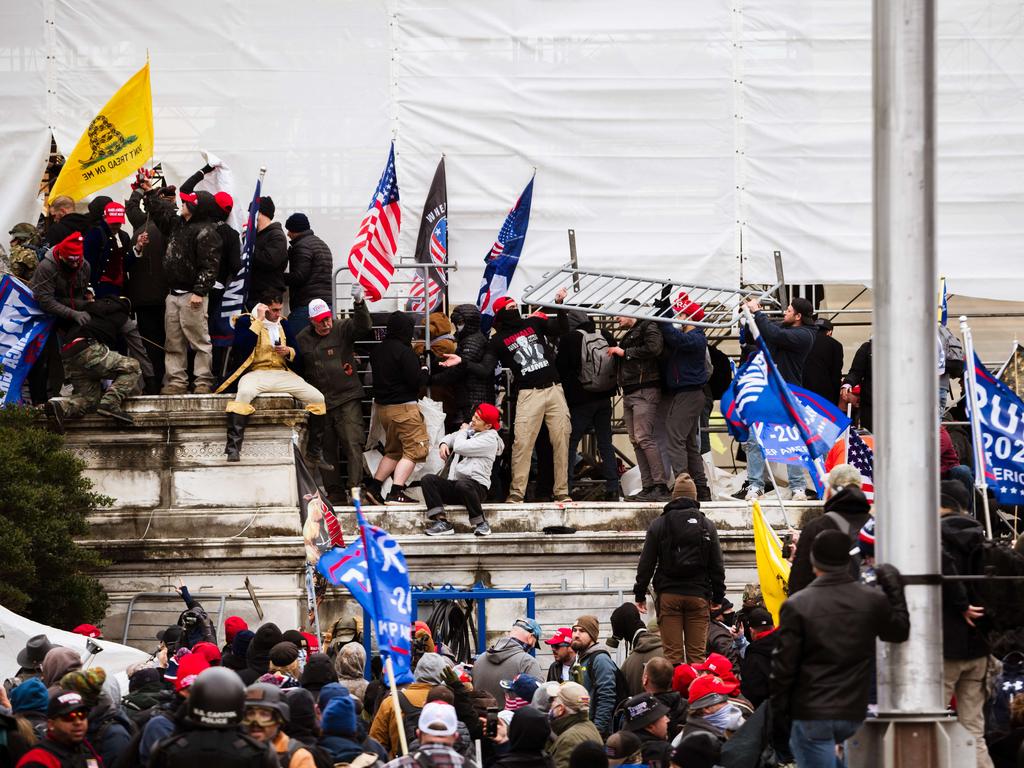 A group of pro-Trump protesters climb the walls of the Capitol Building after storming the West lawn on January 6. Picture: Jon Cherry/Getty Images/AFP.