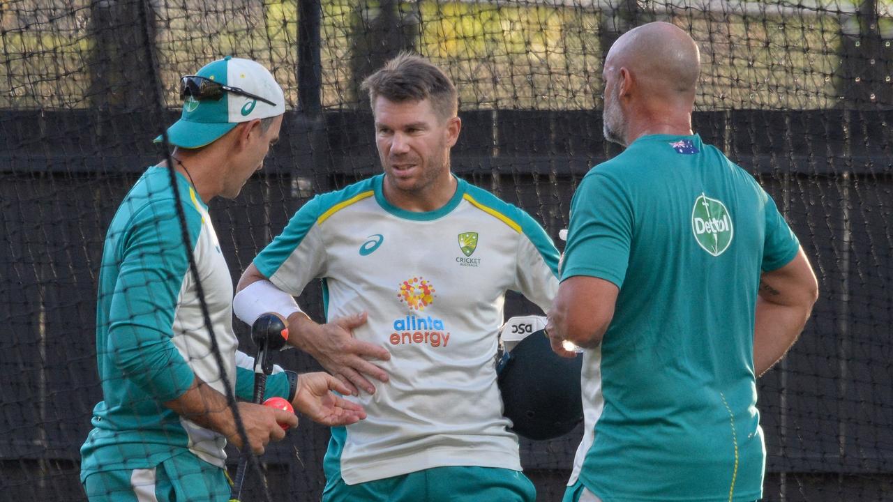 David Warner held a debrief with Australia coach Justin Langer (left) after a net session at Adelaide Oval. Picture: Brenton Edwards/AFP