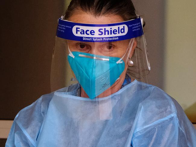 MELBOURNE, AUSTRALIA - NewsWire Photos JUNE 15, 2021:  Health workers arrive to check on tenants of the townhouse complex at Wells street in SouthBank after the Victorian government place the tenants on a mandatory 14-day quarantine. Picture: NCA NewsWire / Luis Ascui