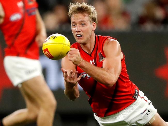 MELBOURNE, AUSTRALIA - APRIL 01: Darcy Parish of the Bombers handpasses the ball during the 2022 AFL Round 03 match between the Melbourne Demons and the Essendon Bombers at the Melbourne Cricket Ground on April 01, 2022 In Melbourne, Australia. (Photo by Dylan Burns/AFL Photos via Getty Images)