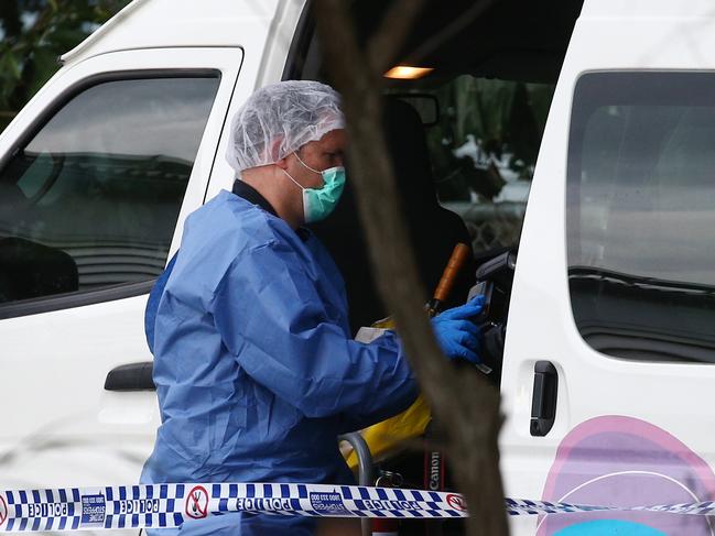 Police officers attend Hambledon State School at Edmonton, where a 3 year old was found dead in a Goodstart Early Learning Centre minibus at around 3:30pm on Tuesday. A police forensic officer inspects the van. PICTURE: BRENDAN RADKE