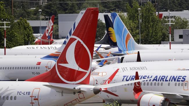 Dozens of grounded 737 MAX airplanes crowded a Boeing parking field on June 27; Boeing said deliveries of commercial jetliners fell by more than a third in the first half of 2019. PHOTO: ELAINE THOMPSON/ASSOCIATED PRESS