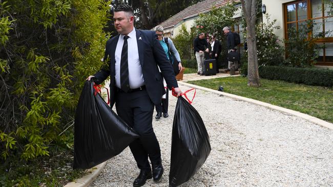 Australian Federal Police (AFP) officers are seen leaving a house believed to be of a former government media adviser during a raid in Canberra, Wednesday, September 4, 2019. (AAP Image/Lukas Coch) NO ARCHIVING