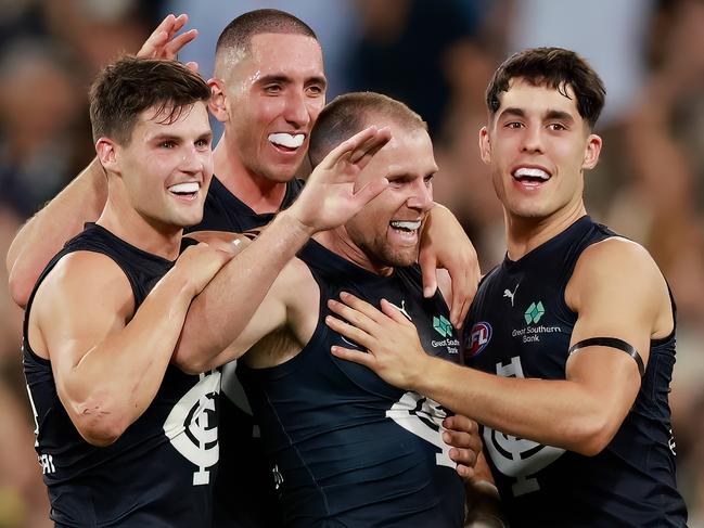 MELBOURNE, AUSTRALIA - MARCH 16: Sam Docherty of the Blues celebrates a goal with Jacob Weitering, Nic Newman and Adam Cerra of the Blues during the 2023 AFL Round 01 match between the Richmond Tigers and the Carlton Blues at the Melbourne Cricket Ground on March 16, 2023 in Melbourne, Australia. (Photo by Dylan Burns/AFL Photos via Getty Images)