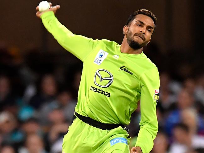 Arjun Nair of the Thunder bowls during the Big Bash League (BBL) cricket match between the Brisbane Heat and the Sydney Thunder at the Gabba in Brisbane, Tuesday, December 17, 2019. (AAP Image/Albert Perez) NO ARCHIVING, EDITORIAL USE ONLY, IMAGES TO BE USED FOR NEWS REPORTING PURPOSES ONLY, NO COMMERCIAL USE WHATSOEVER, NO USE IN BOOKS WITHOUT PRIOR WRITTEN CONSENT FROM AAP