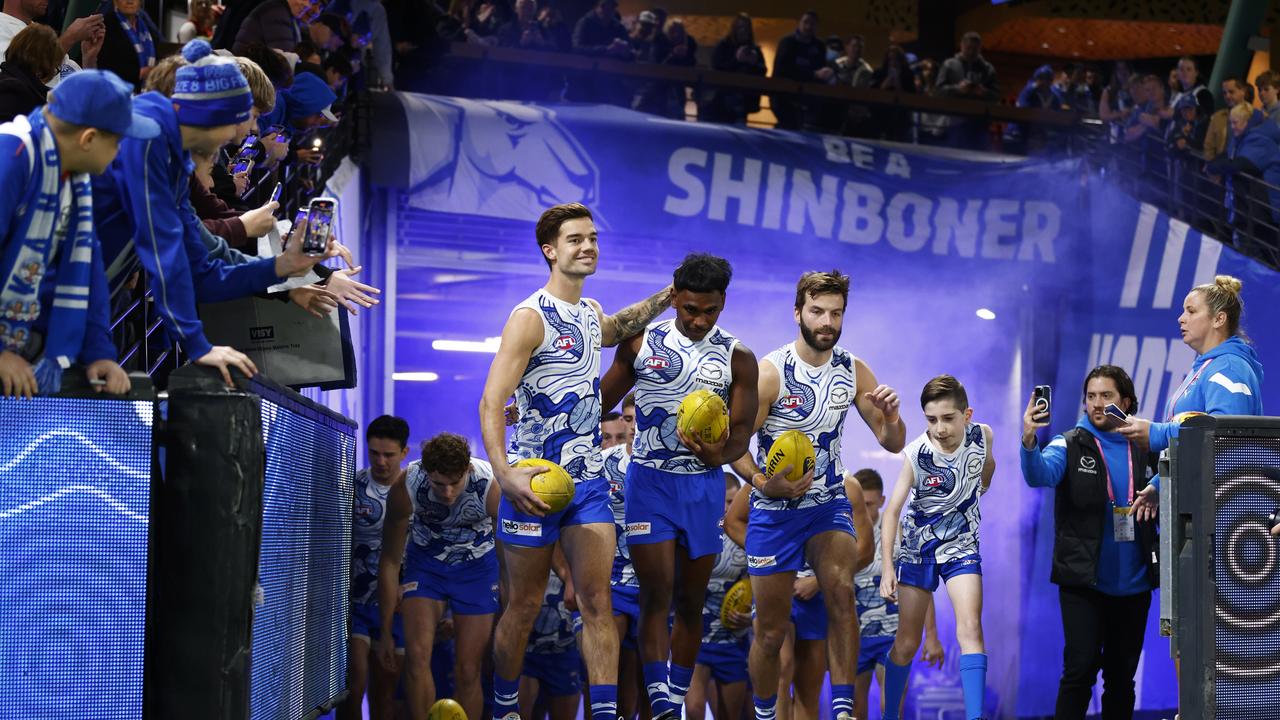 MELBOURNE, AUSTRALIA - MAY 20: Jy Simpkin of the Kangaroos and Phoenix Spicer of the Kangaroos lead the team out during the round 10 AFL match between North Melbourne Kangaroos and Sydney Swans at Marvel Stadium, on May 20, 2023, in Melbourne, Australia. (Photo by Daniel Pockett/Getty Images)