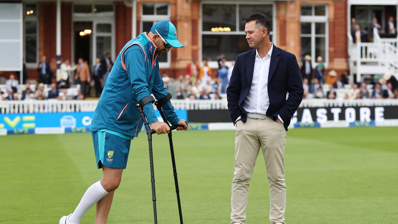 Lyon, hobbled and on crutches, speaks to Ricky Ponting before his batting heroics. Picture: Getty