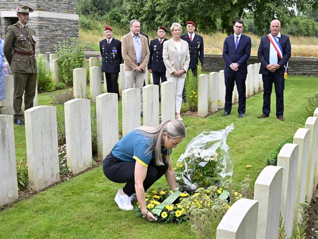 Australian Olympic officials and Australian cyclist, Kaarle McCulloch places a wreath on the grave of Cecil Healy on July 17, 2024 in Assevillers, France. Picture: Kristy Sparow/Getty Images for the AOC