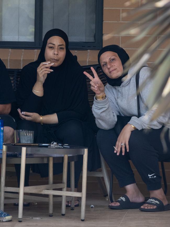 Associates of Sarah Abu Lebdeh outside her Condell Park home on Wednesday afternoon.