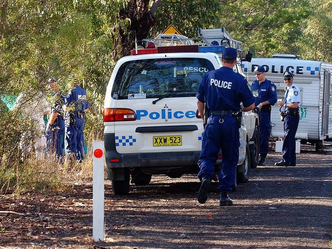 3/6/03 Police at the scene where a body was found off the old Pacific Highway north of Mooney Mooney Picture: MARK SCOTT