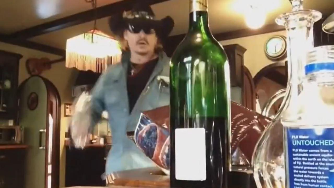 Depp was seen storming around the kitchen wearing a cowboy hat and sunglasses as he poured himself a large glass of wine.