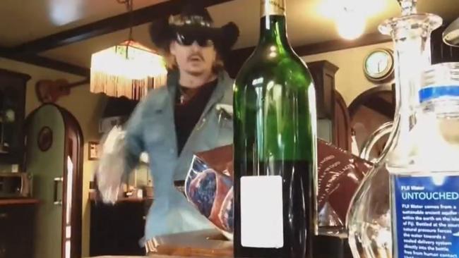 Depp was seen storming around the kitchen wearing a cowboy hat and sunglasses as he poured himself a large glass of wine.