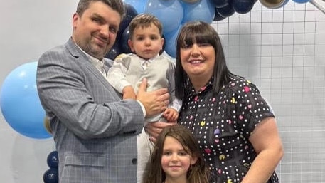 Melbourne dad Anthony Becker, pictured with his family, is the first person in the world to receive the new surgical implant for Crohn’s disease.