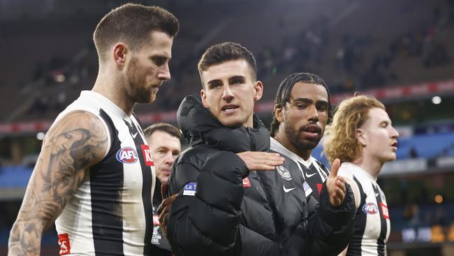 MELBOURNE, AUSTRALIA - AUGUST 05: Nick Daicos of the Magpies (C) walks off the field with Jeremy Howe (L) and Isaac Quaynor of the Magpies (2R) as Magpies head coach Craig McRae (L2) looks on during the round 21 AFL match between Hawthorn Hawks and Collingwood Magpies at Melbourne Cricket Ground, on August 05, 2023, in Melbourne, Australia. (Photo by Daniel Pockett/Getty Images)