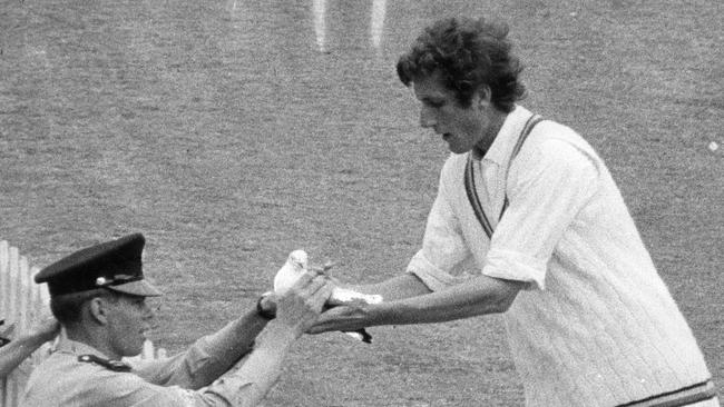 England's Bob Willis hands over to Police Cadet Tony Walsh a seagull temporarily stunned by a rocket-like leg glance from Australian opening batsman Keith Stackpole.