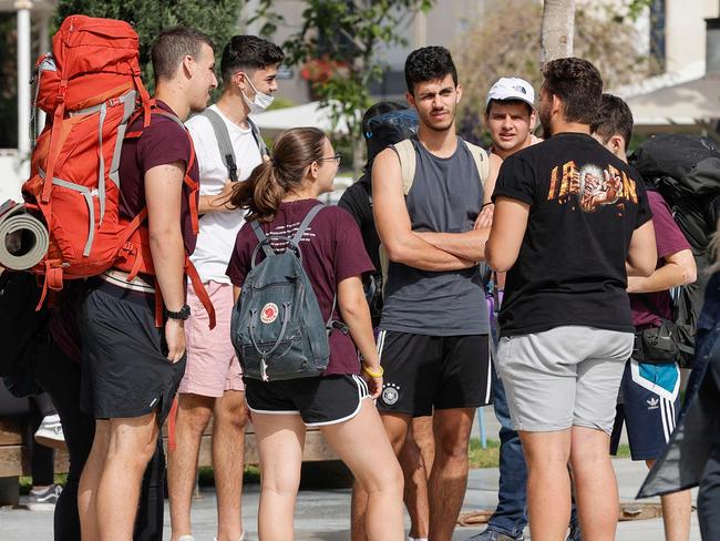 Youths gather on a street in the Israeli coastal city of Tel Aviv after authorities announced that face masks for COVID-19 prevention were no longer needed outside. Picture: AFP