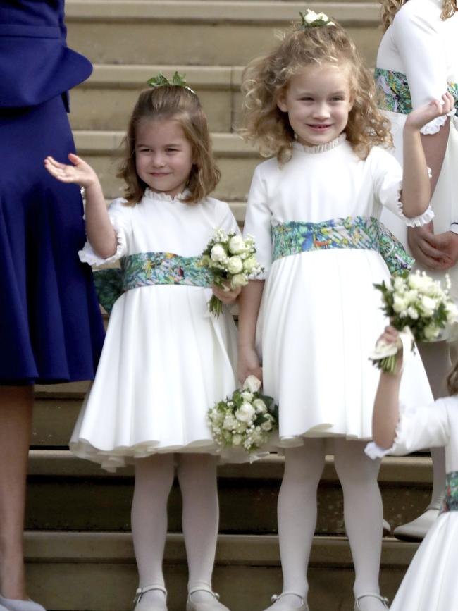 Princess Charlotte waves to the newlyweds after their wedding ceremony. Picture: AFP