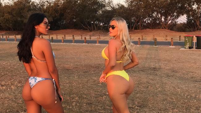 Ultra Tune ad stars Parnia Porsche (left, brunette) and Tyana Hansen pose up at The Spit on the Gold Coast earlier this month before departing for Las Vegas to shoot the latest commercial with Mike Tyson. The pair are based on the Gold Coast and say they don't care about complaints the ads typically generate.