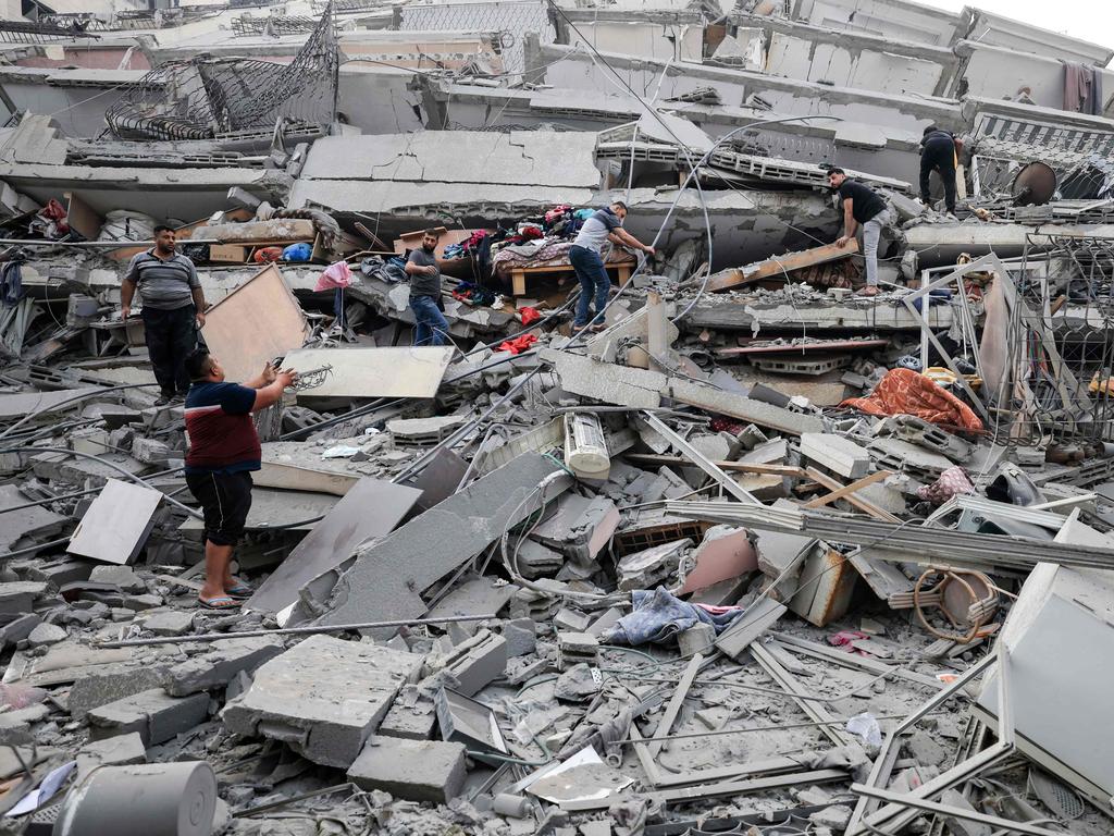 Residents salvage some belongings from a building that collapse during an Israeli air strike in Gaza City. Picture: AFP