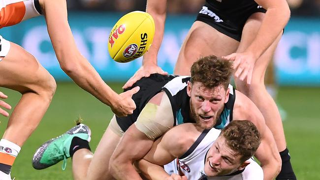 Port Adelaide’s Brad Ebert tackles Giants Jacob Hopper in the round 18 match at Adelaide Oval. Picture: Mark Brake/Getty