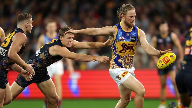 Daniel Rich of the Lions kicks the ball from Jordan Dawson of the Crows during the 2023 AFL Round 11 match between the Adelaide Crows and the Brisbane Lions at Adelaide Oval on May 28, 2023 in Adelaide. Picture: Sarah Reed/AFL Photos via Getty Images.