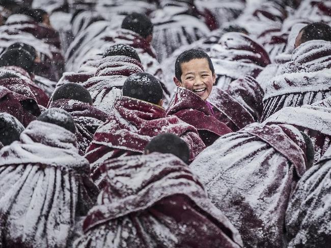 Smile ... During a Dharma assembly in the monastery of Labrang Lamasery, due to the heavy snow, all the monks’ robes were covered with a thick layer of snow. When a young Lama was looking back with a smile, the photographer captured his smiling face. Location: Labrang Lamasery, Tibetan Autonomous Prefecture of Gannan, Gansu Province, China. Picture: Jianjun Huang (CN)/Siena International Photo Awards 2016