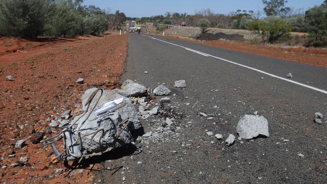 A 250kg block of concrete from the bridge lays 330m up the highway from the scene of the blast. Picture: Peter Wallis