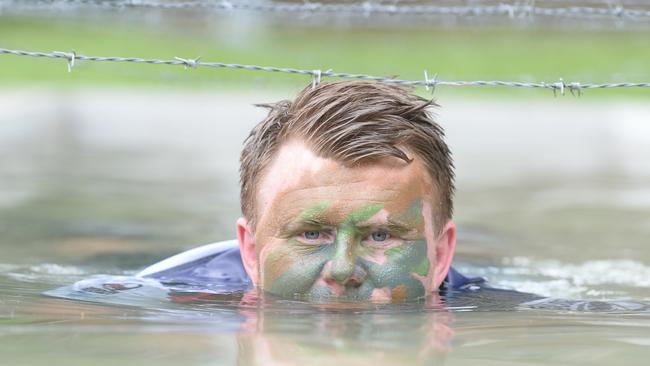 The Australian Army are partnering with the Gold Coast Cyclones representative rugby program to cement the relationship between the Canungra base troops and the Coast. Cyclones players at the base ground warfare obstacle course at Kokoda Barracks. Scott Stokes negotiates the barbed wire obstacle course. Picture: Lawrence Pinder