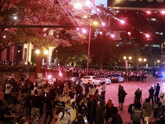 Police set off a crowd-dispersal firework in front of City Hall as several hundred people gather to protest over the death of George Floyd in Columbus, Ohio. Picture: Doral Chenoweth/The Columbus Dispatch via AP