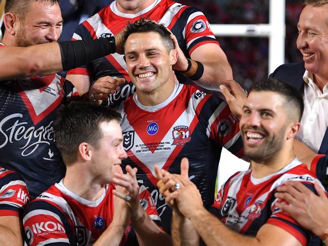 Cooper Cronk (centre) celebrates with teammates and coach Trent Robinson following their win in the 2019 NRL Grand Final between the Canberra Raiders and the Sydney Roosters at ANZ Stadium in Sydney, Sunday, October 6, 2019. (AAP Image/Dan Himbrechts) NO ARCHIVING, EDITORIAL USE ONLY