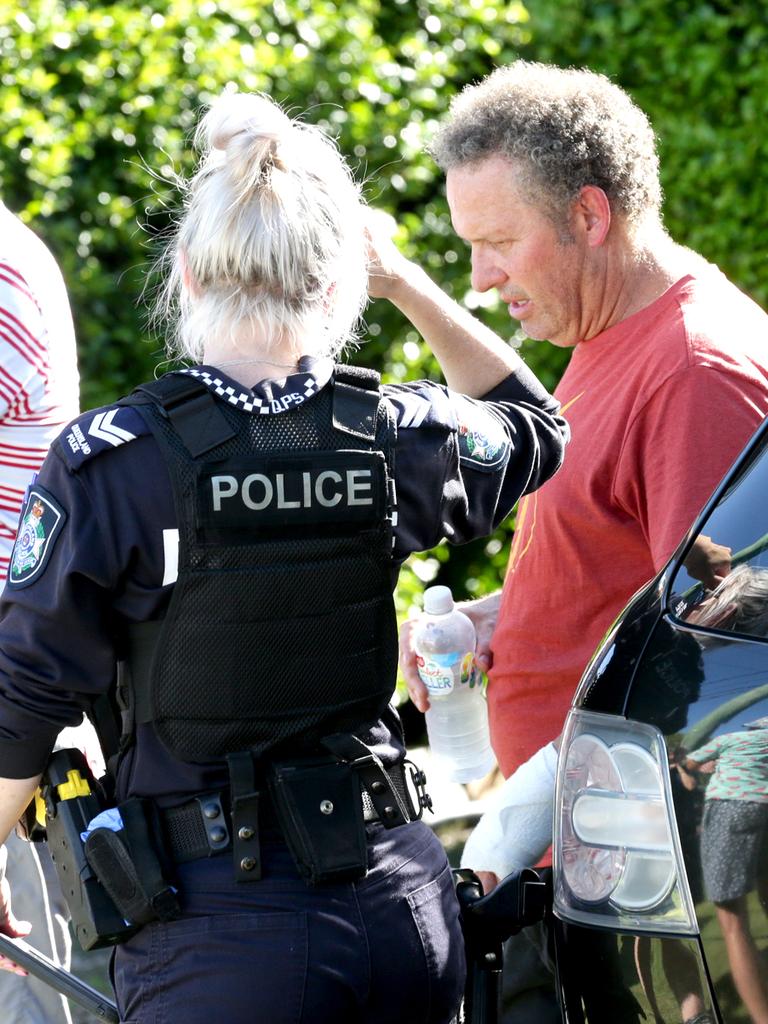 A man talks to police at the scene. Picture: Steve Pohlner