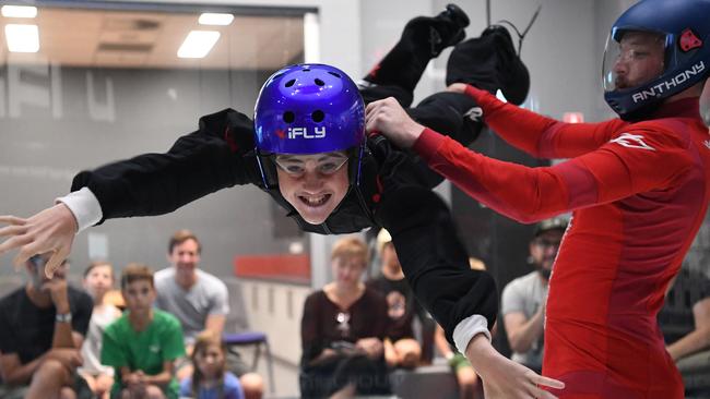 Cooper Smith (left) flys with the help of iFLY Melbourne instructor Anthony Skipsey at the recently opened flying simulator in Essendon Fields, Tuesday, January 28, 2020. (Photo/Julian Smith)