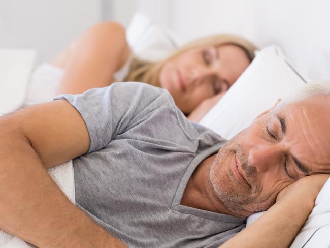 Senior man and woman sleeping. Senior man and woman resting with eyes closed. Mature couple sleeping together in their bed.