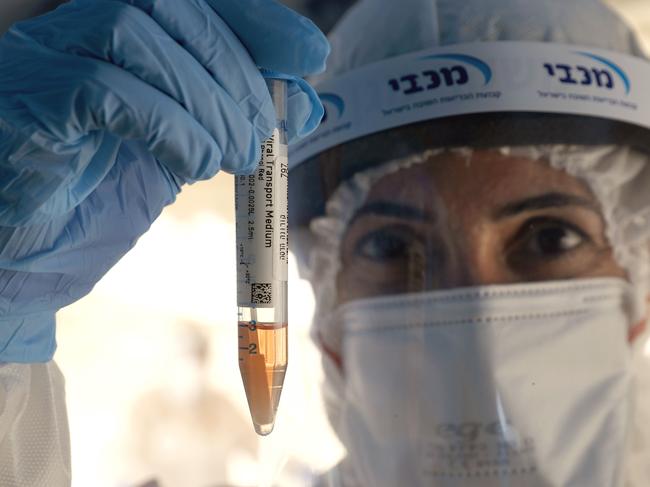 Israeli medical personnel take samples at a drive through COVID-19 testing facility in Ramat Hasharon in the suburbs of Tel Aviv. Picture: AFP