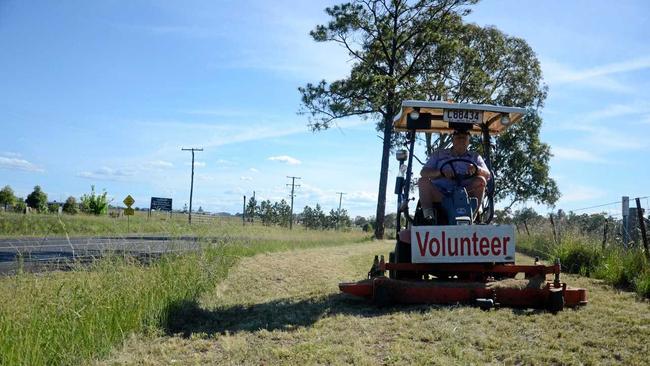 Graham Buchner slashing grass along the side of the road into west Warwick. Picture: Ben Wilmott