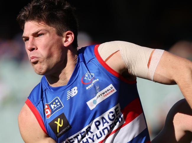 Hugo Munn from the Bulldogs is tackled by Will Gould from Glenelg during the SANFL preliminary final match between Central Districts and Glenelg at the Adelaide Oval in Adelaide, Sunday, September 15, 2024. (SANFL Image/David Mariuz)