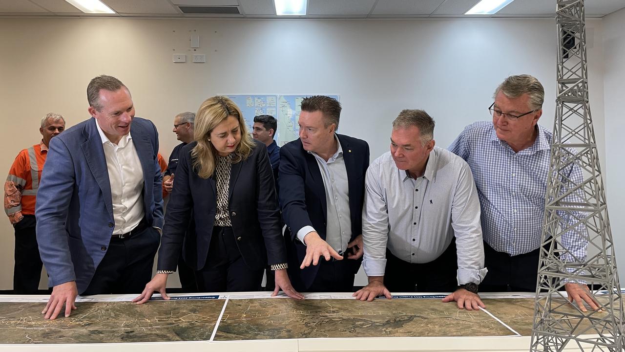 Queensland Premier Annastacia Palaszczuk and co inspect a map of the upcoming CopperString SuperGrid power transmission line, set to run from Townsville to Mount Isa.