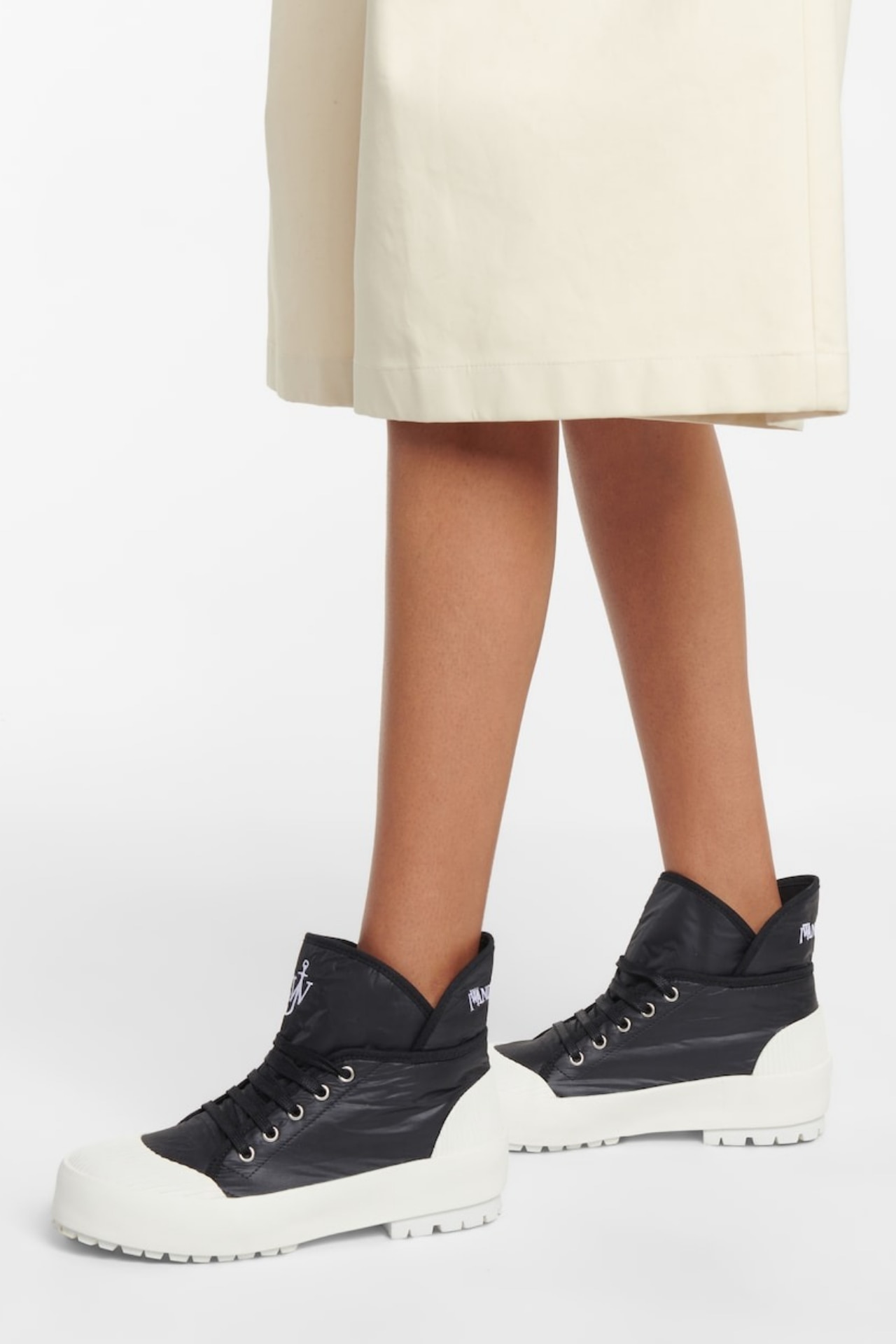 <h3><a href="https://www.mytheresa.com/au/en/women/designers/jw-anderson" target="_blank" rel="nofollow noopener"><b>JW Anderson</b></a></h3><p><strong>High-top sneakers</strong></p><p>Not for the faint-hearted, but you&rsquo;re guaranteed compliments if you take these bold JW Anderson high-tops out for a spin. The jet black leather, embossed with the label&rsquo;s logo, is a highlight. If you already have a few pairs of white tennis shoes or sporty runners in your closet, let JW Anderson take you outside of your comfort zone&mdash;you won&rsquo;t be disappointed.</p><p><b>Material: </b>Cotton, rubber and grained leather | <b>Colour range: </b>Black | <b>Type: </b>High-top sneaker | <b>Delivery:</b> Free shipping over $800</p><p class="button-common"><a title="SHOP NOW FOR $358" href="https://www.mytheresa.com/au/en/women/jw-anderson-high-top-sneakers-black-p00586035" target="_blank" data-cta="SHOP NOW FOR $358" data-editable="true">SHOP NOW FOR $358</a></p><p class="button-common"><a title="Vogue" href="javascript:rampart.signup('https://www.vogue.com.au/shopping/best-designer-sneakers-women/image-gallery/4059e68968428934890f5660c5bb5354');" target="_self" data-cta="Vogue" data-editable="true">Sign up to our newsletter</a></p>