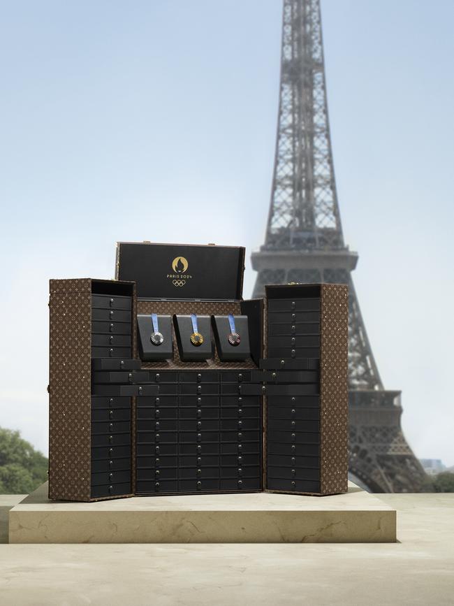 The Louis Vuitton medal trunk in front of the Eiffel Tower.