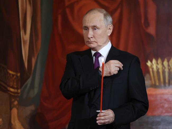 Russian President Vladimir Putin holds a candle during an Orthodox Easter service at the Christ the Saviour cathedral in Moscow. Picture: AFP