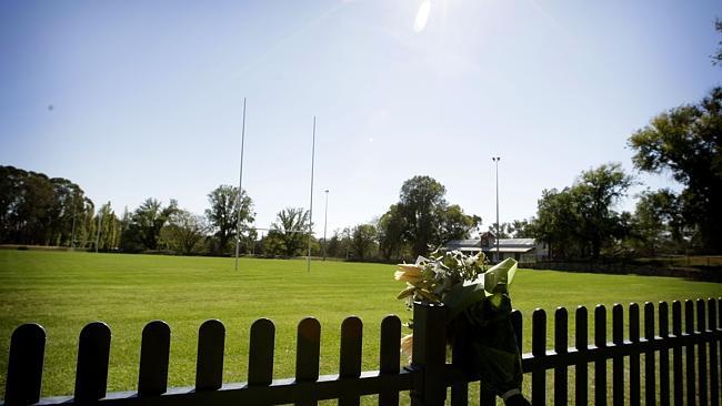 Flowers left on the fence surrounding at the Brumbies training field after Shawn Mackay died.  