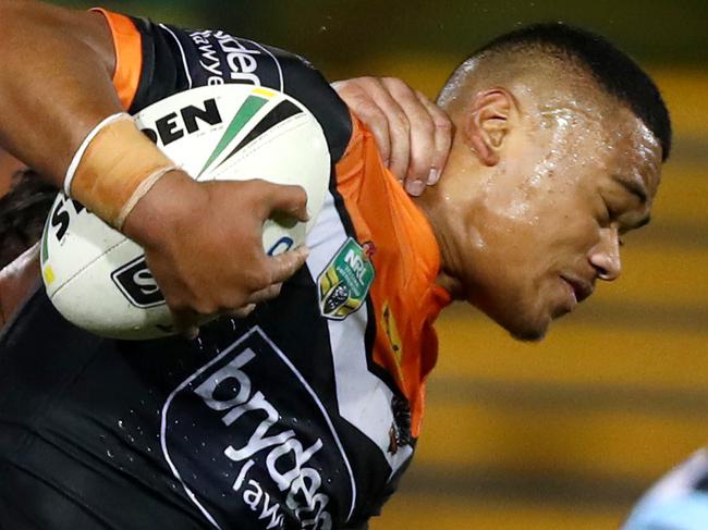 Tigers Moses Suli attempts to bust the tackle of the Shark's Matt Prior during NRL  game between the Wests Tigers and the Newcastle Knights at Leichhardt Oval . Picture : Gregg Porteous