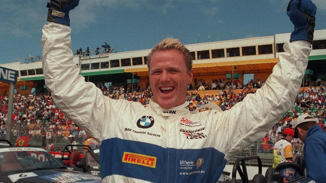 Former AFL player & TV personality Dermott Brereton raises arms in victory 07/03/99 after winning celebrity race at Albert Park prior to 1999 Australian Formula One (F1) Grand Prix.Australian Rules P/