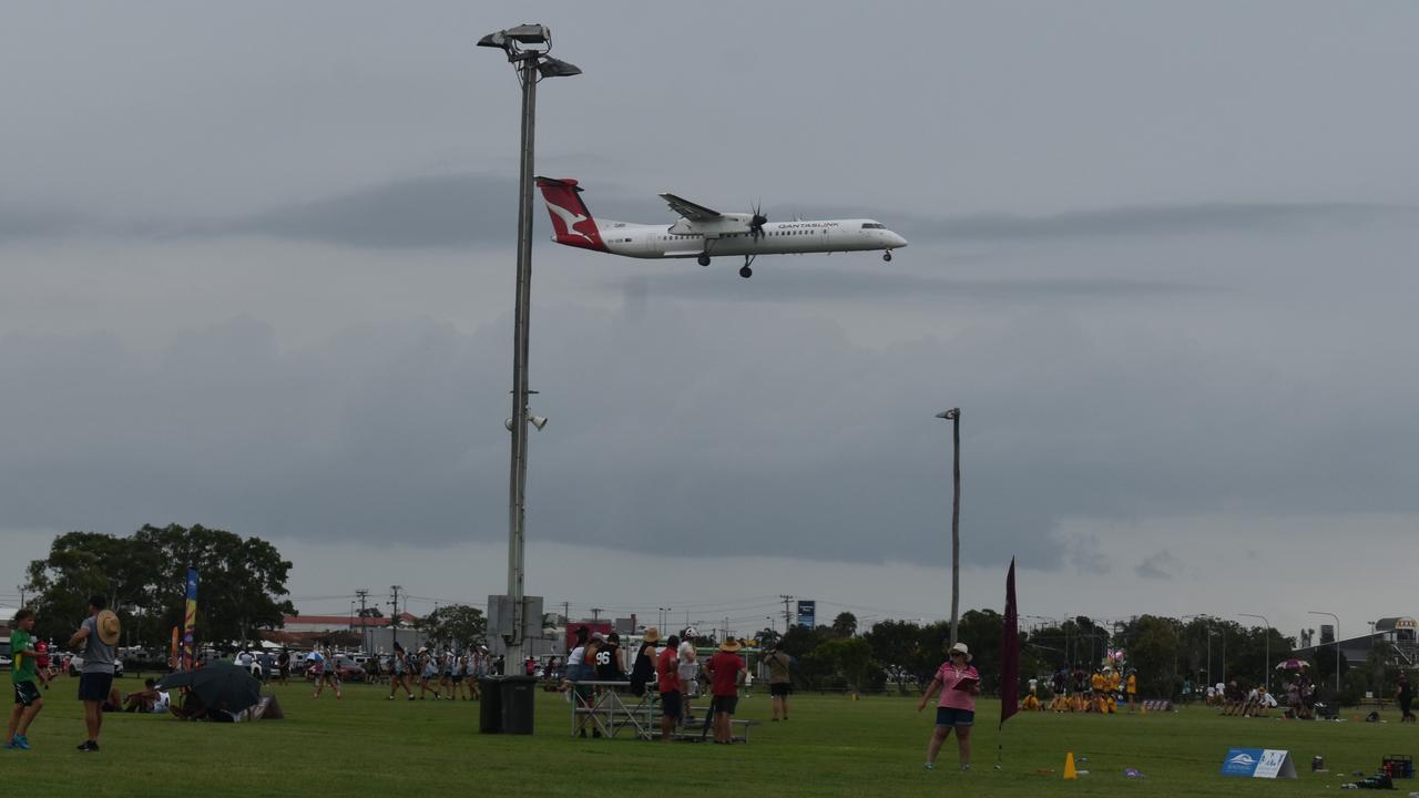 A plane comes in to land at Bundaberg Airport near the touch grounds.