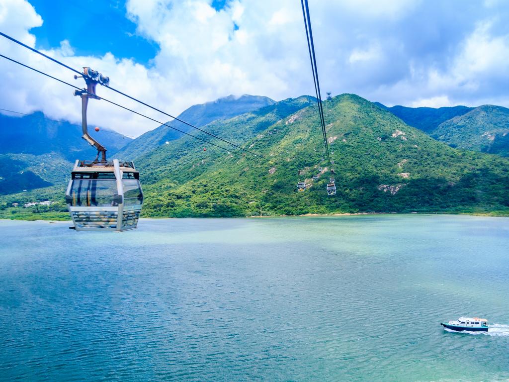 A cable car makes it way across to the green mountains of Lantau Island. Picture: iStock