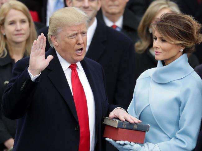 Donald Trump takes the oath of office as his wife Melania Trump holds the bible. Picture: Chip Somodevilla/Getty Images/AFP