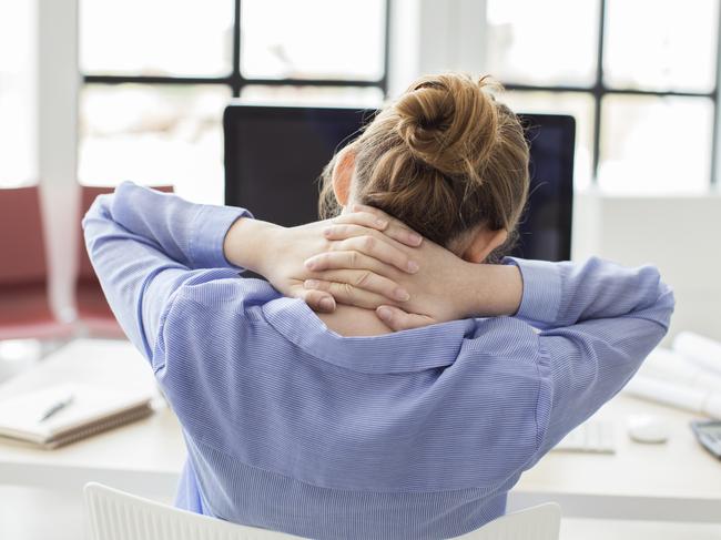 Tired businesswoman holding her nape