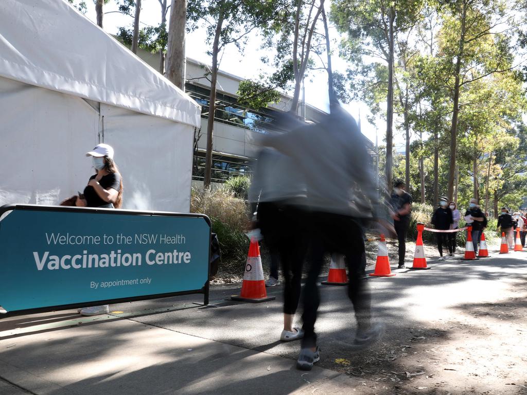 People are seen queued to receive their vaccination at the NSW Vaccine Centre at Homebush Olympic Park in Sydney Picture: NCA NewsWire / Christian Gilles