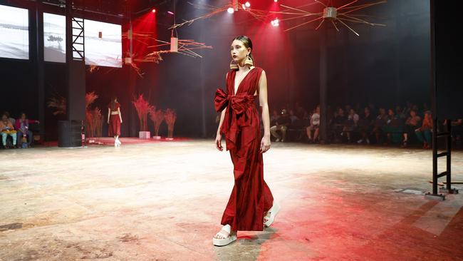 A model showcases the Yarrabah Affirmations collection by the Yarrabah Arts & Culture Precinct at the Cairns Indigenous Art Fair fashion performance, Woven, held at the Tanks Arts Centre, Edge Hill. Picture: Brendan Radke